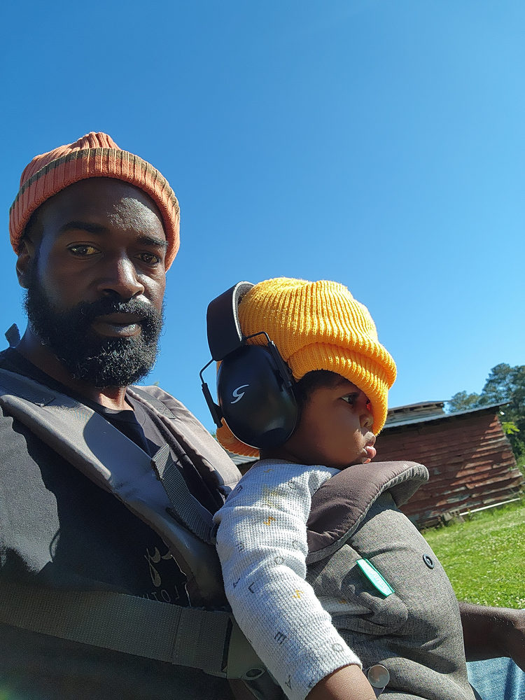 Anthony Beedles on the farm with his child
