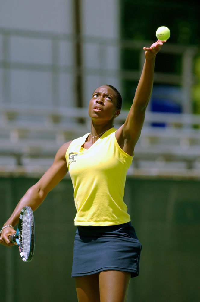 Whitney McCray serving a tennis ball